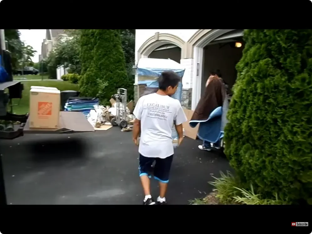 Movers preparing household items for transport